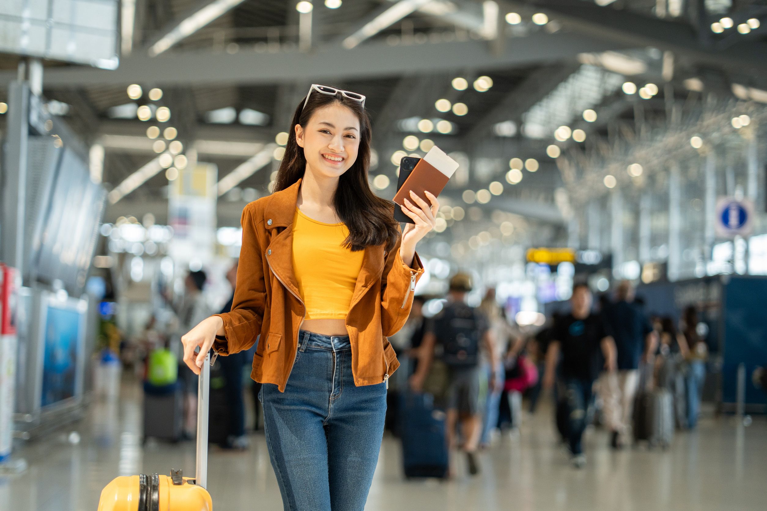 Asian Woman Traveler With Smartphone And Boarding Pass