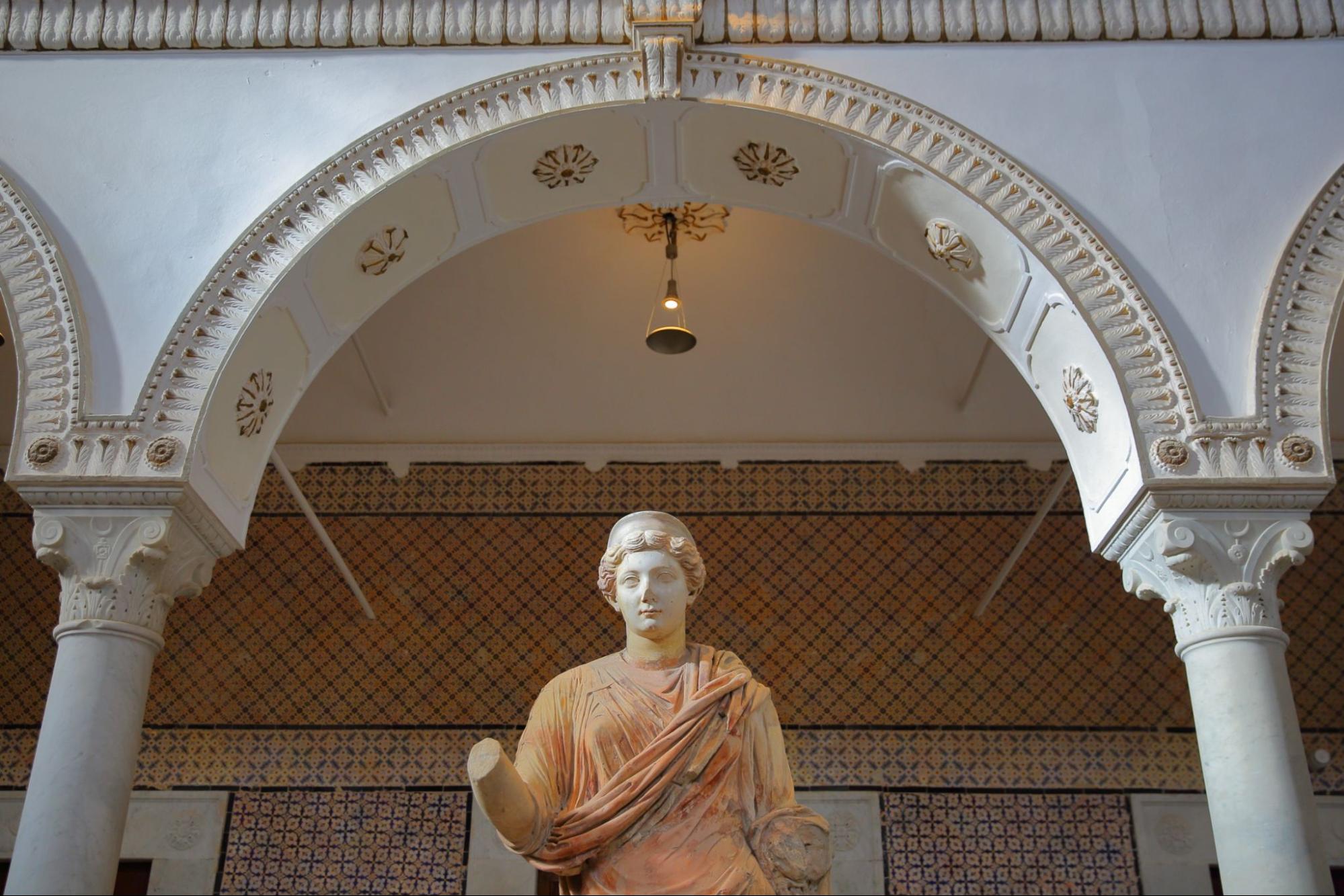 The Carthage room inside the Bardo Museum with close-up on a roman sculpture with arcades and columns