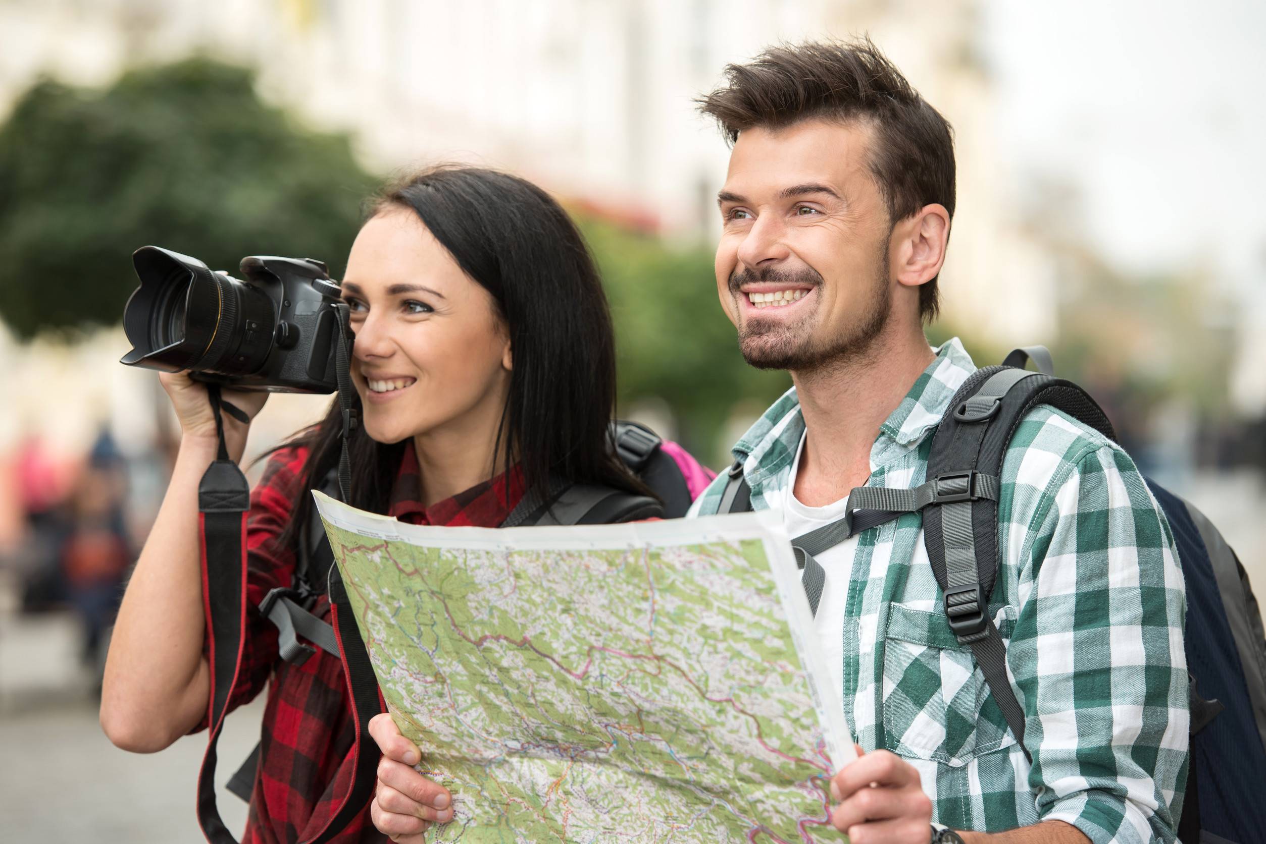 Two Young Tourists With Backpacks