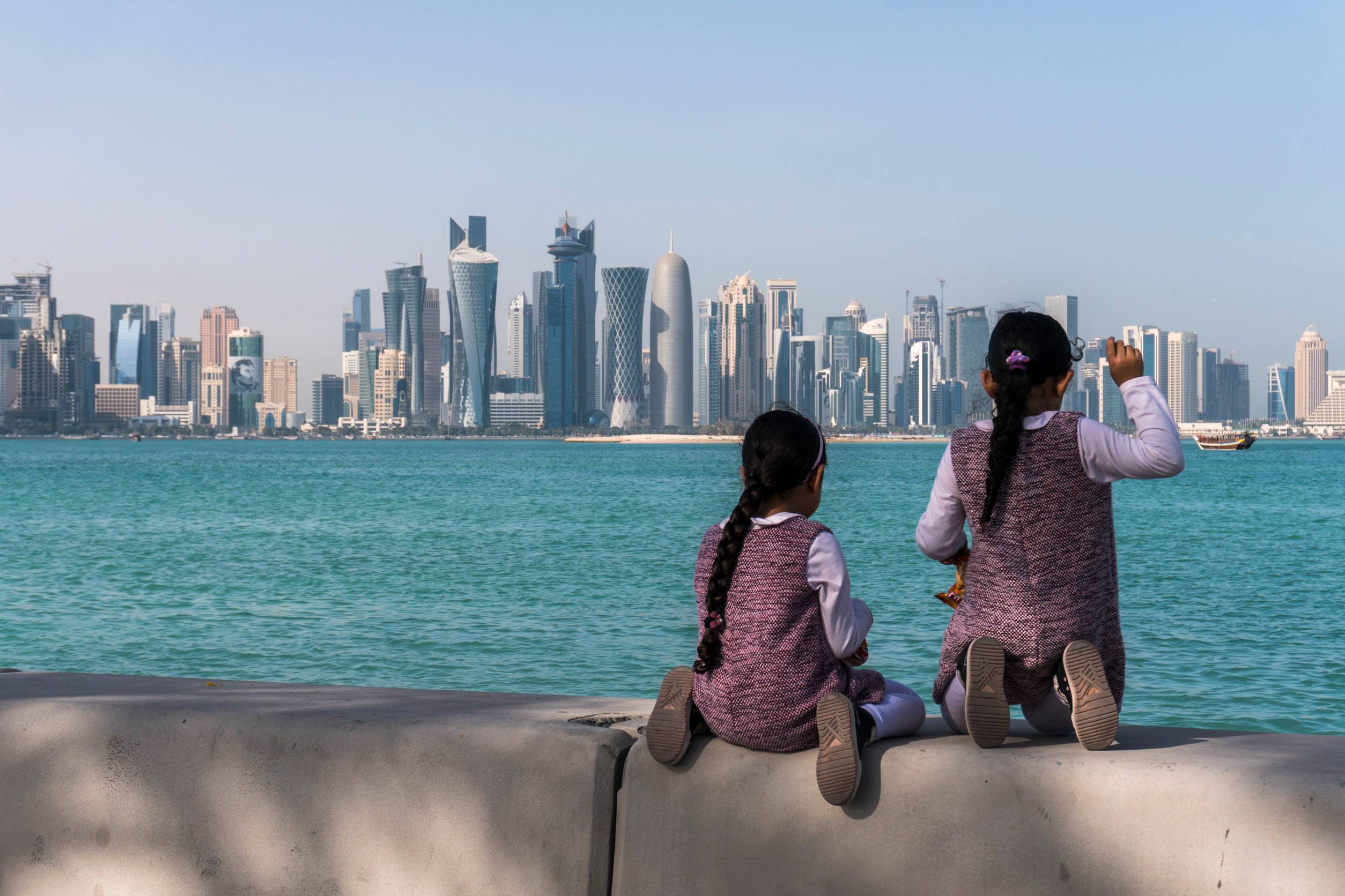 Twolittle Child Girls Sitting On Corniche Broadway Qatar Twolittle Child Girls Sitting On Corniche Broadway Qatar